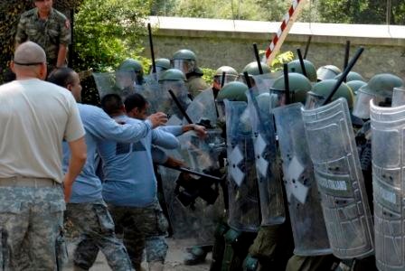 Multinational riot control training, U.S. soldiers play rioters