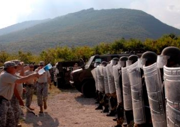 Multinational riot control training, U.S. soldiers play rioters