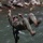 1/1 Marines Begin Exercise Mountain Warrior at Bridgeport A military service member in camouflage uniform is crossing a fast-moving river using a rope traverse or zip line system. The individual is suspended horizontally over the water, gripping the rope with both hands while their legs swing outward, suggesting rapid movement. This appears to be a military training exercise involving water obstacle crossing techniques.