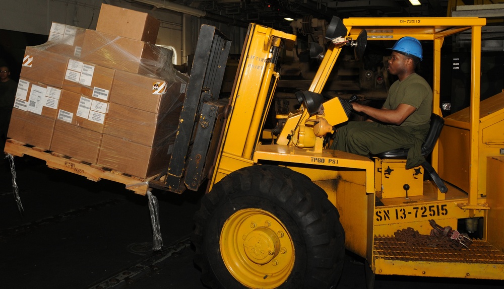 Sailors prepare relief supplies for Pakistan