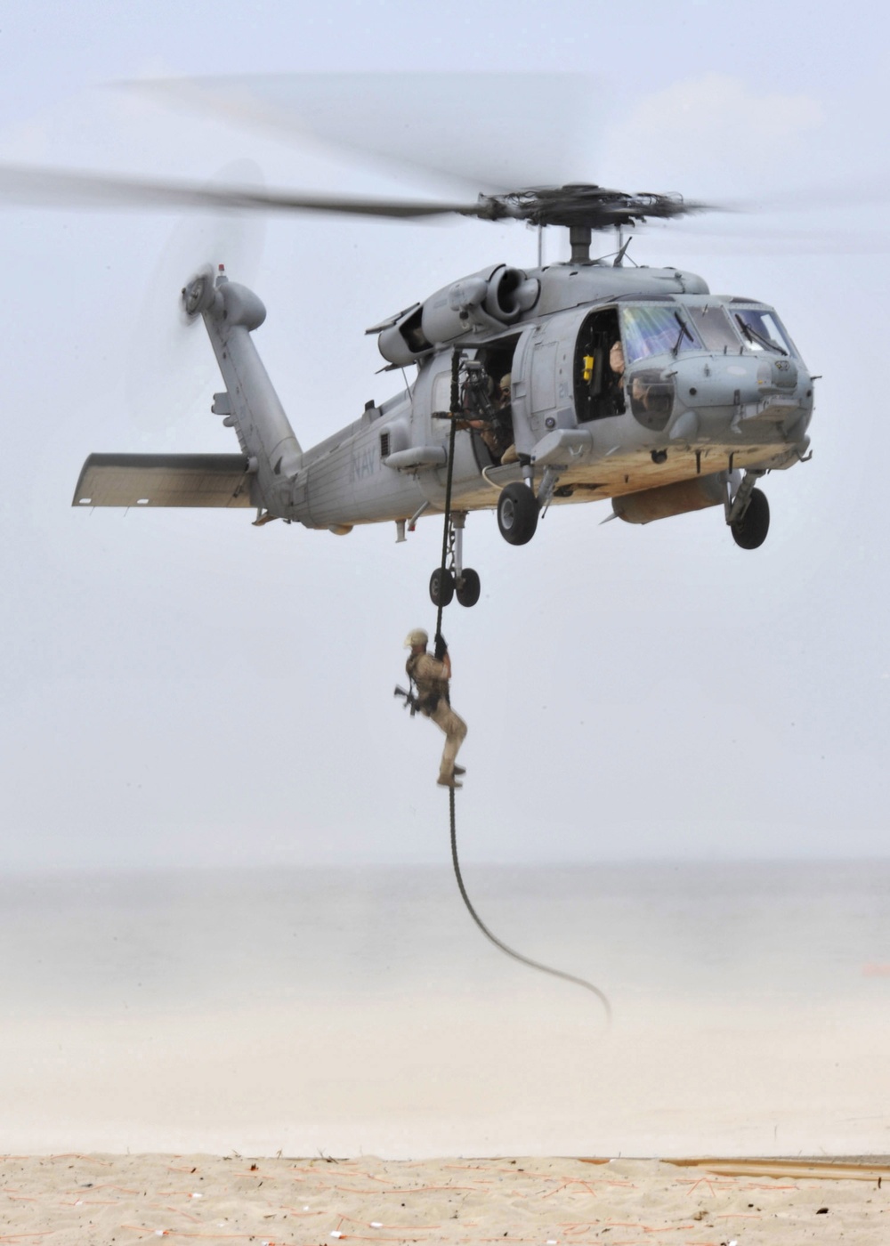 U.S. Navy SEALs Fast Rope Onto the Beach During Their Capabilites Exercise Saturday, July 17, 2010 on Joint Expeditionary Base Little Creek, Va.