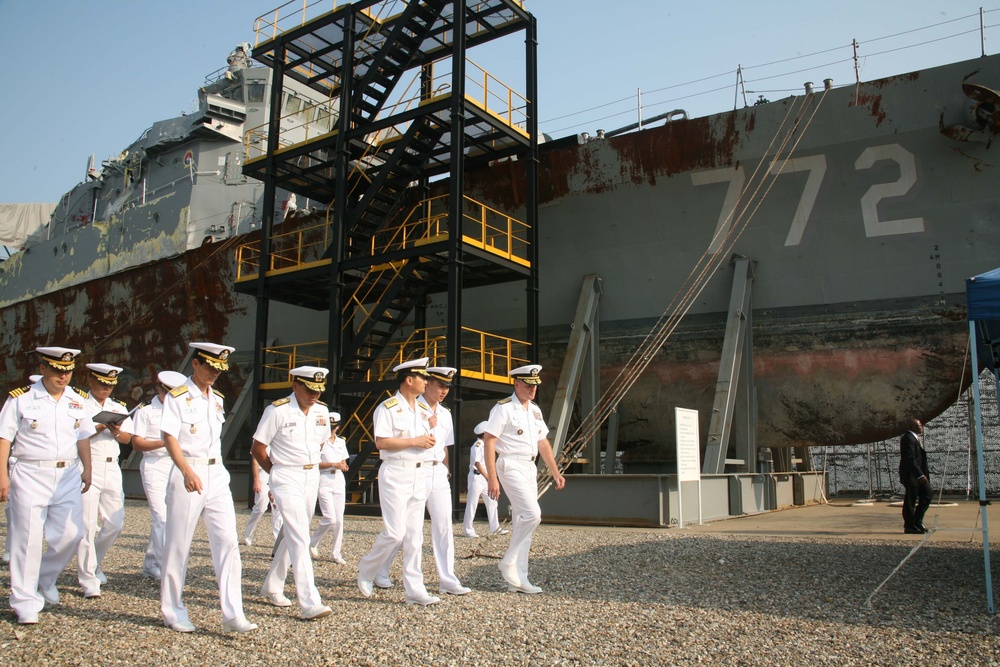 Sailors examine North Korean-attacked ship