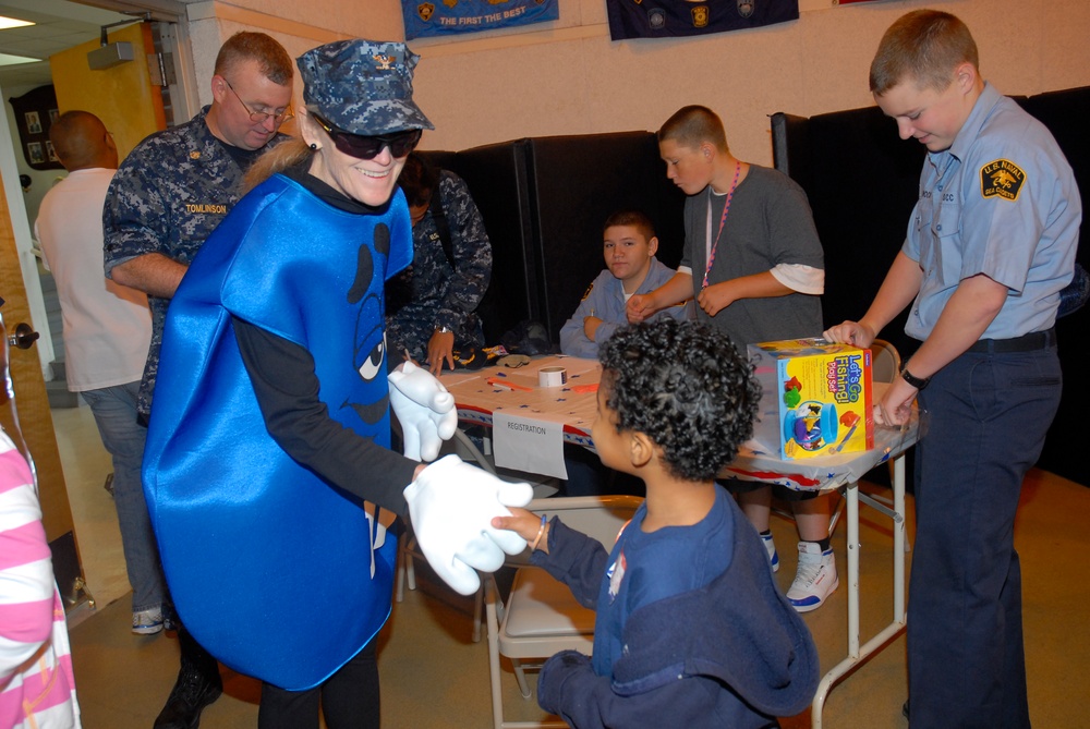 Sailor entertains child at conference