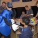 Sailor entertains child at conference