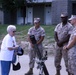 Staff Sgt. Ron Tinsley and Pfc. Anthony Flores talk to a Korean War veteran's wife about a current Marine Corps 81mm mortar weapon system at the reunion held Sept. 16. The Marines from Company C, Battalion Landing Team, 1st Battalion, 1st Marine Regiment,
