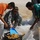Soldiers help Iraqi citizens harvest dates on Camp Ramadi