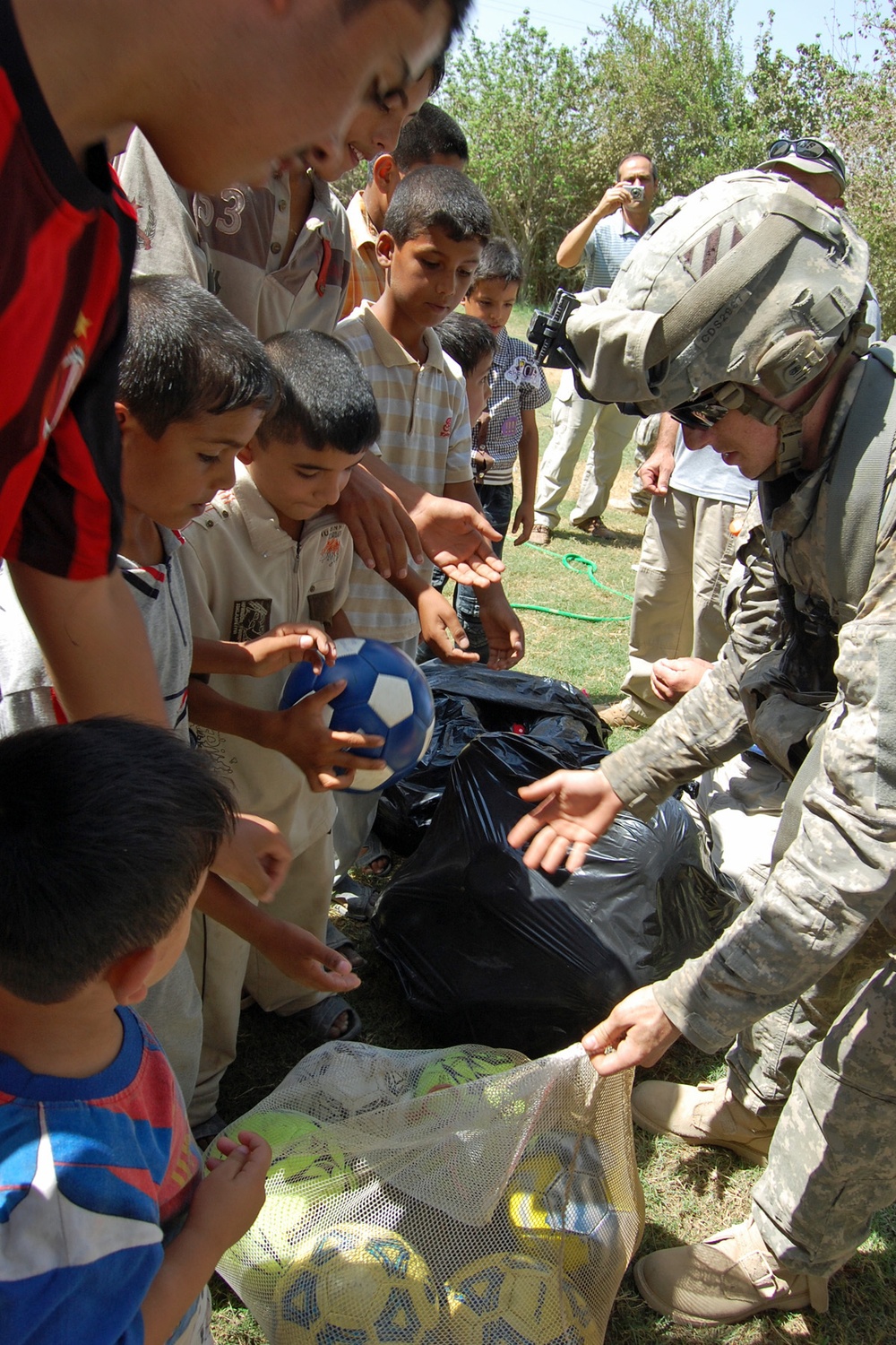 USD-C Soldier Builds Trust, One Soccer Ball at a Time: Father, Son Offer Gift of Play to Iraqi Children