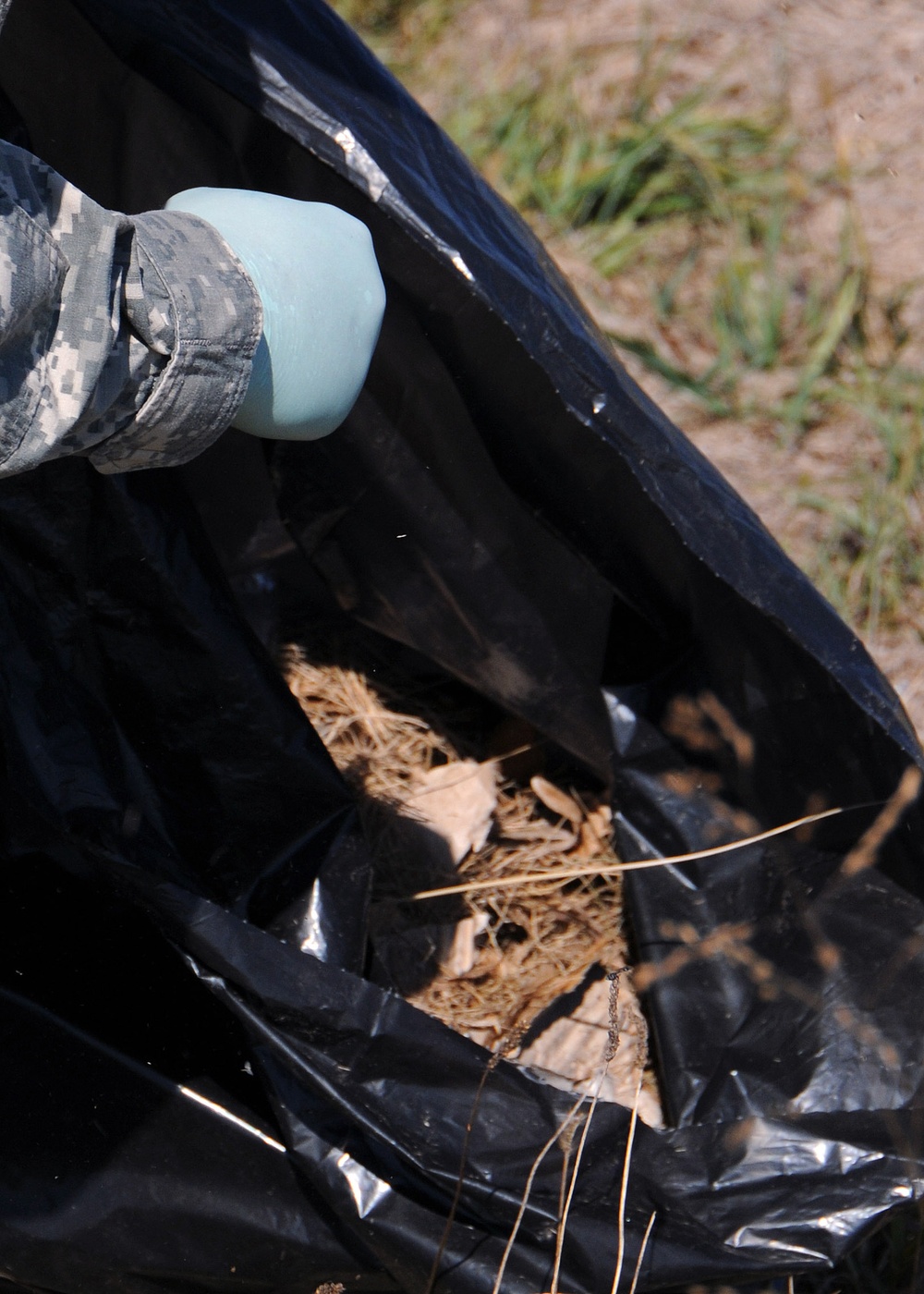 Soldiers pick up litter