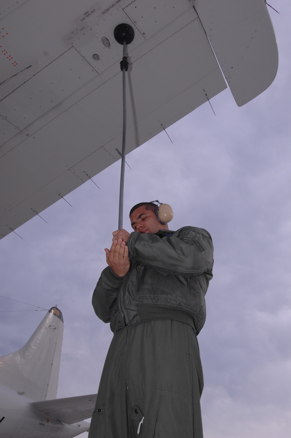 VP-9 Crew Members Conduct Preflight Checks on P-3 Aircraft