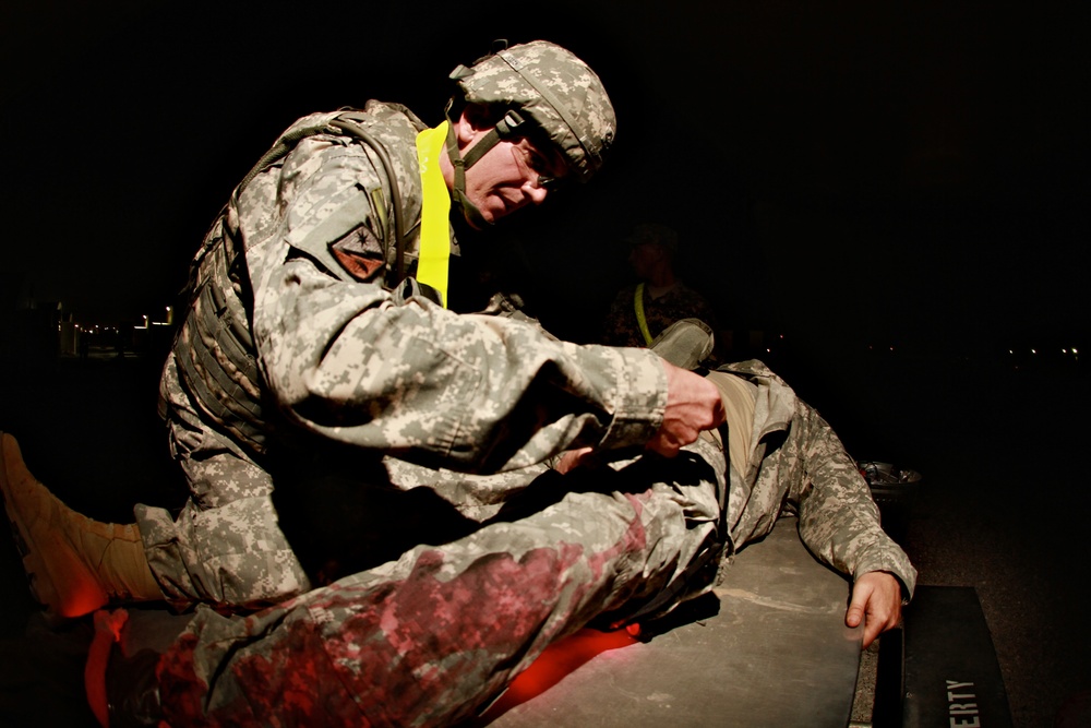 Spc. Stearns, a Paralegal Specialist with the 1st Sustainment Brigade, provides medical aid during the Combat Lifesavers Course at Camp Arifjan Kuwait