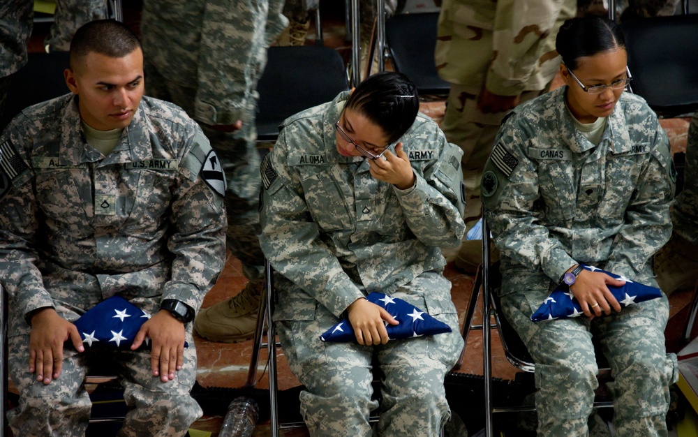 Pfc. Yiraldy Aloma, a native of Panama City, Panama, wipes a tear from her eye after becoming a U.S. citizen during a Veterans Day Naturalization Ceremony sponsored by United States Forces-Iraq at Al Faw Palace on Camp Victory, Iraq. During the ceremony,