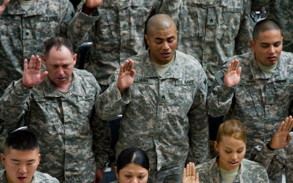 Soldiers take the Oath of Allegiance during a Veterans Day Naturalization Ceremony at Al Faw Palace at Camp Victory, Iraq. During the ceremony, sponsored by United States Forces-Iraq, 50 service members became U.S. citizens.
