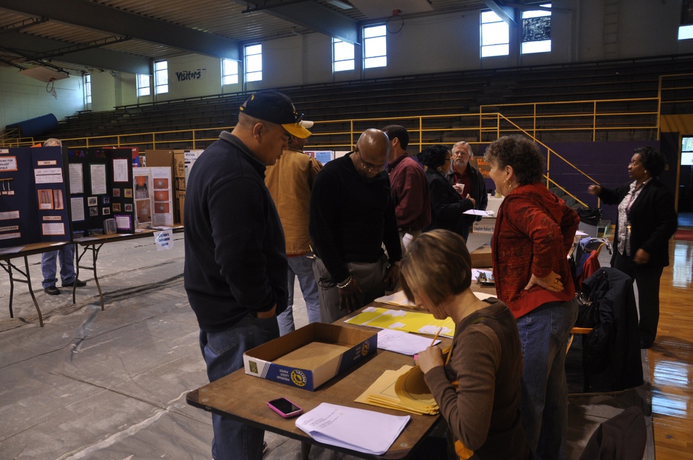 Technician steps outside supply box; judges local science fair entries