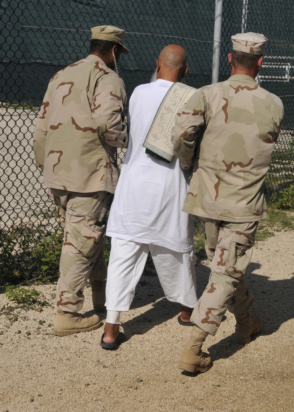 Guards Escort a Detainee in Camp Delta