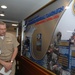Naval Sea Systems Command Commander, Vice Adm. Kevin McCoy, admires the newly unveiled wall display inside the Pentagon, emphasizing the Navy’s commitment to the Combined Federal Campaign