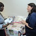 Joyce Scott of Severn, Md., left, chats with Armed Services YMCA staffer, Jennie Mixon, right, about the organization’s Kid Comfort program