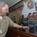 Naval Sea Systems Command Commander, Vice Adm. Kevin McCoy, points to his command’s name on a plaque listing commands that met or exceed significant fundraising goals during previous years on behalf of the Combined Federal Campaign