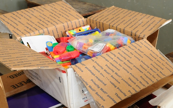 National Guardsmen distribute school supplies