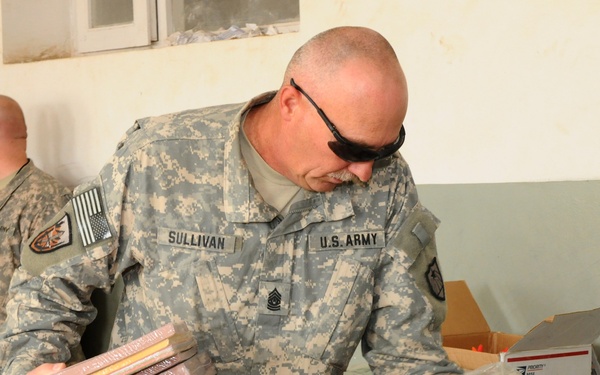 National Guardsmen distribute school supplies