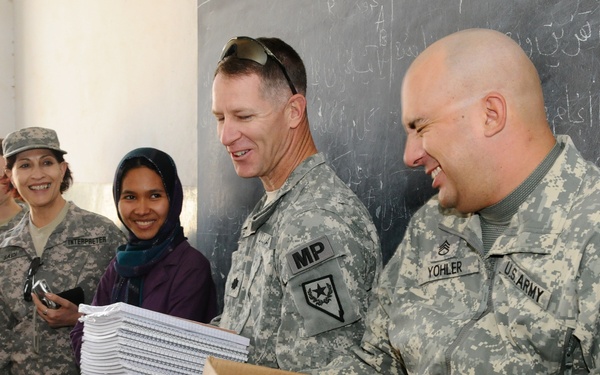 National Guardsmen distribute school supplies