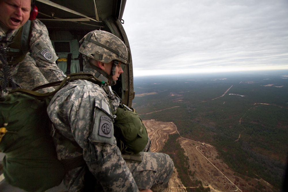 Paratroopers jump from helicopters