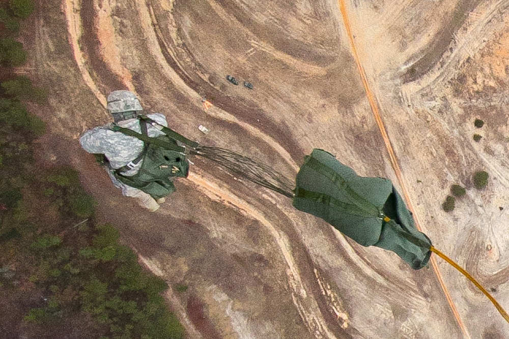 Paratroopers jump from helicopters