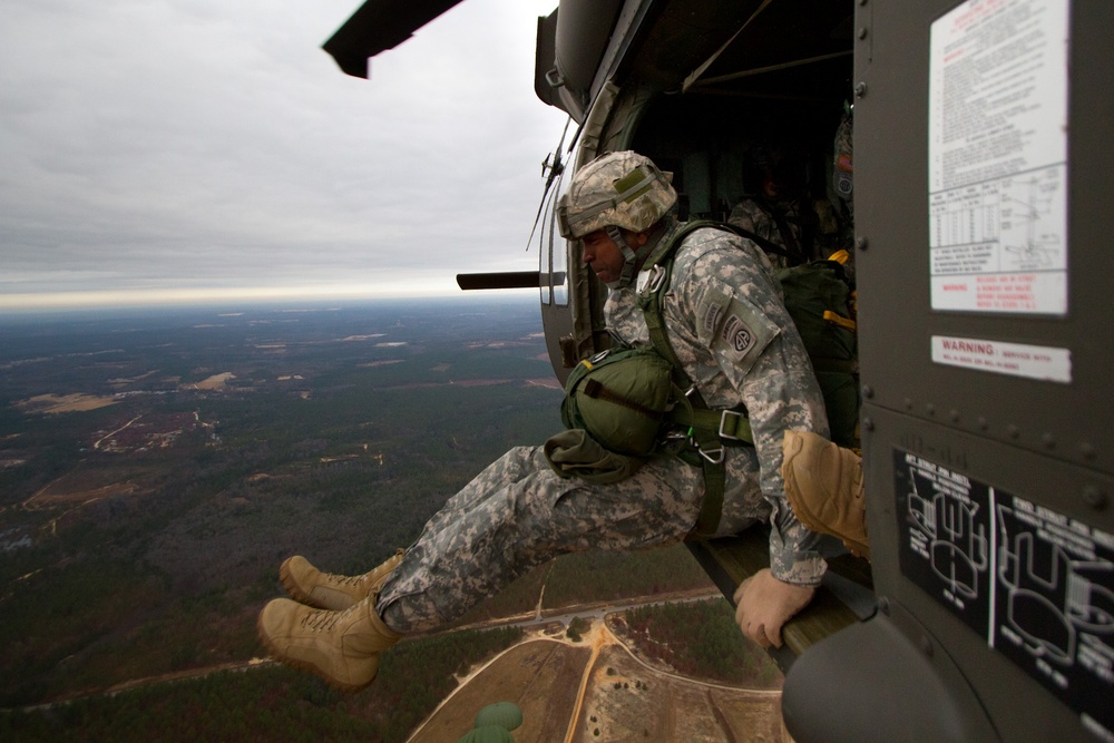 Paratroopers jump from helicopters