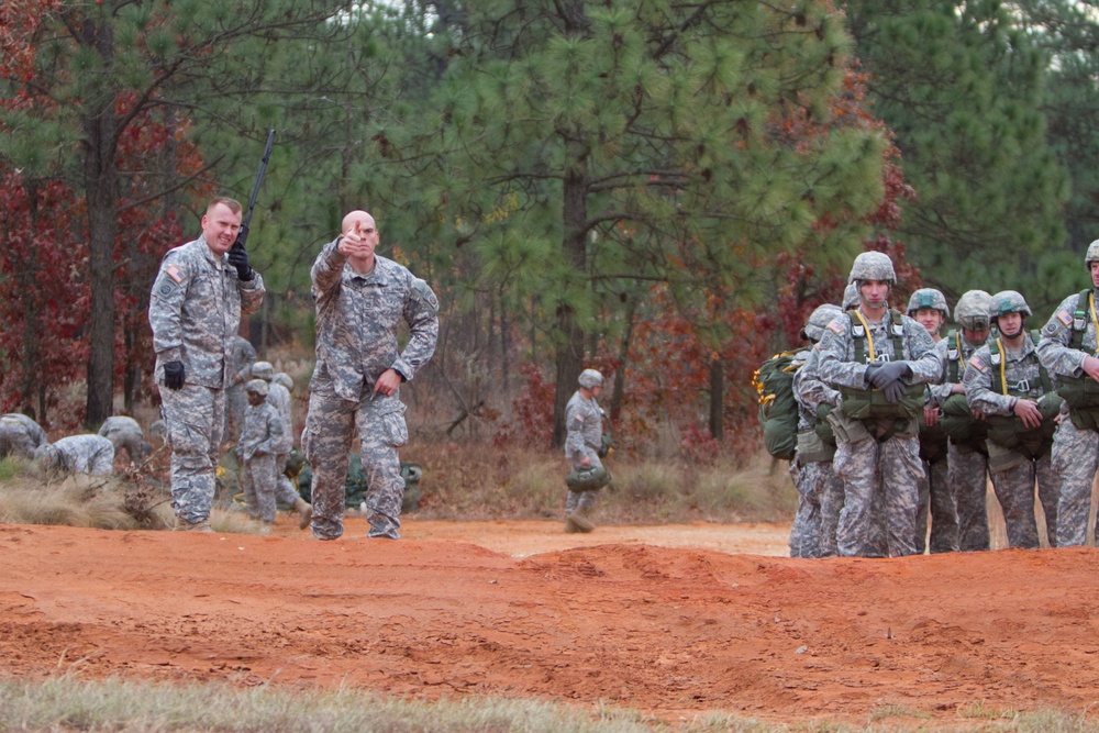 Paratroopers jump from helicopters