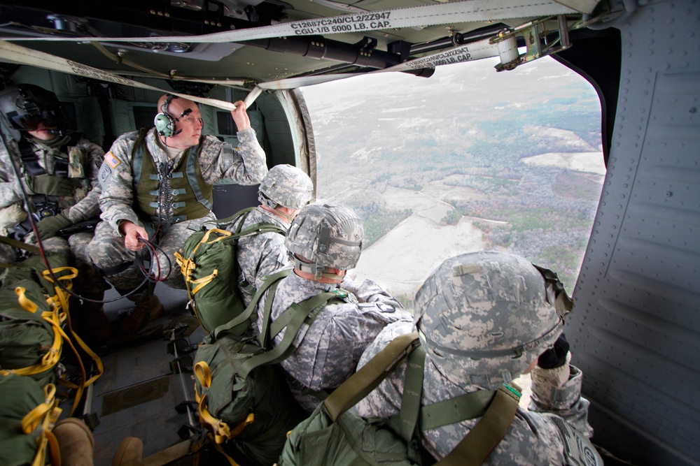 Paratroopers jump from helicopters