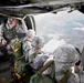 Paratroopers jump from helicopters