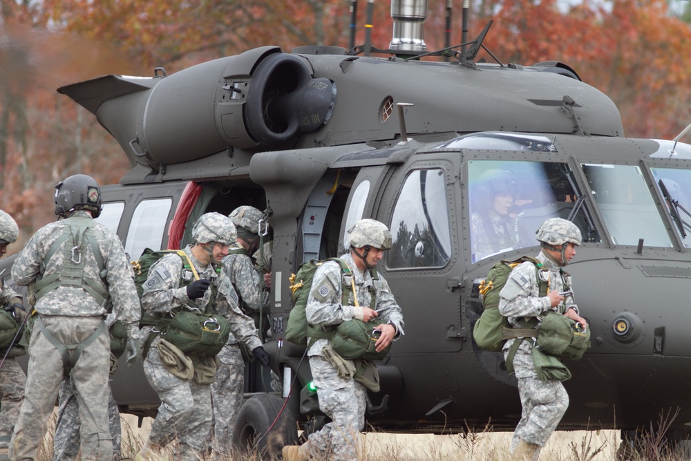 Paratroopers jump from helicopters