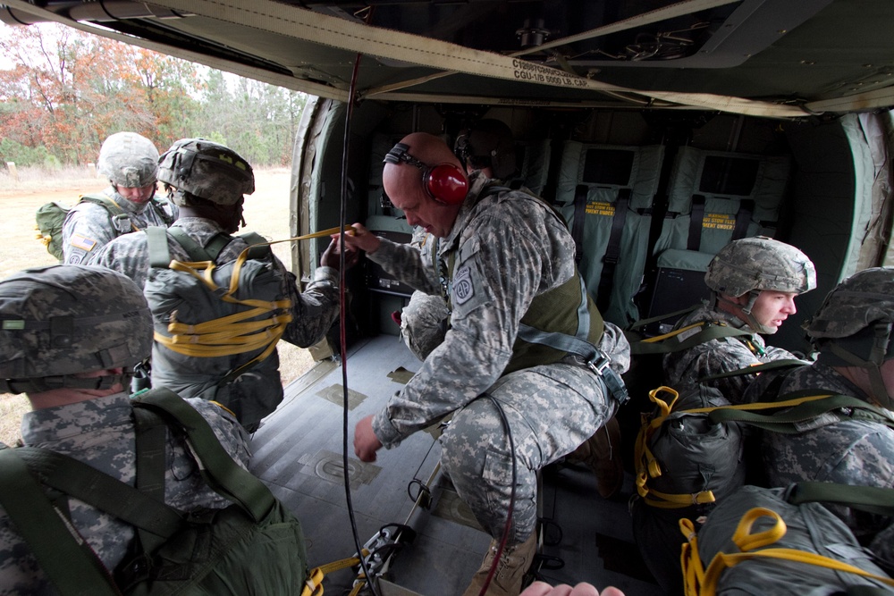 Paratroopers jump from helicopters