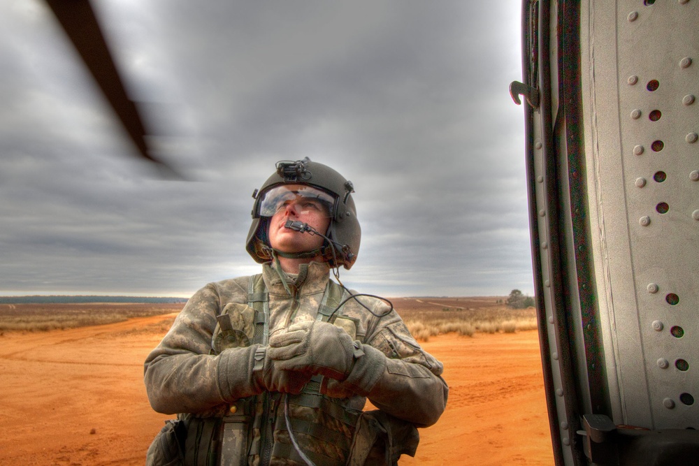 Paratroopers jump from helicopters