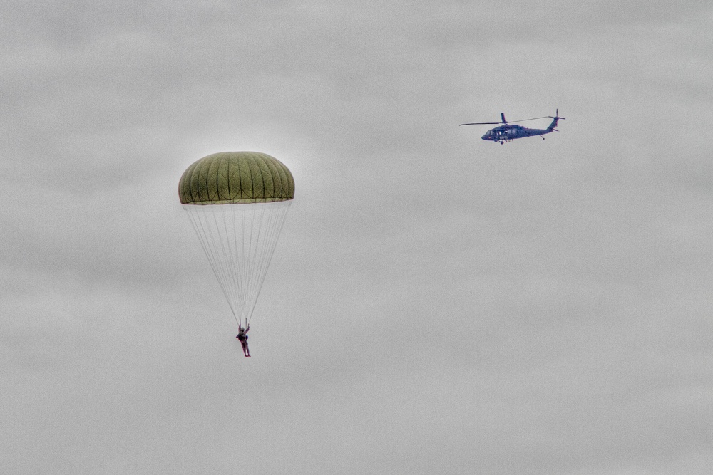 Paratroopers jump from helicopters