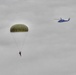 Paratroopers jump from helicopters