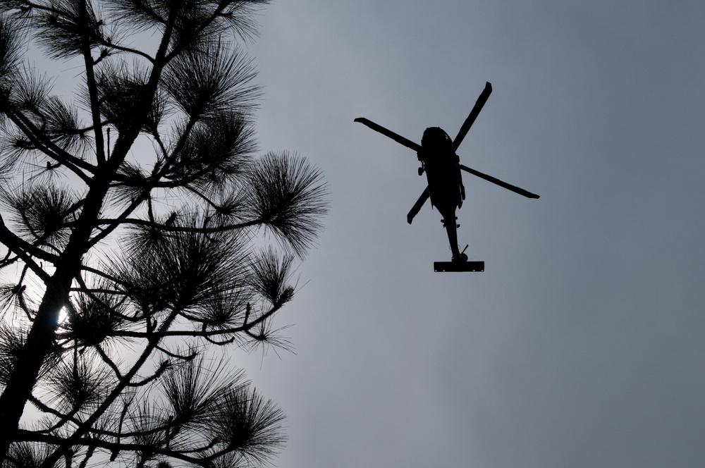 Paratroopers jump from helicopters