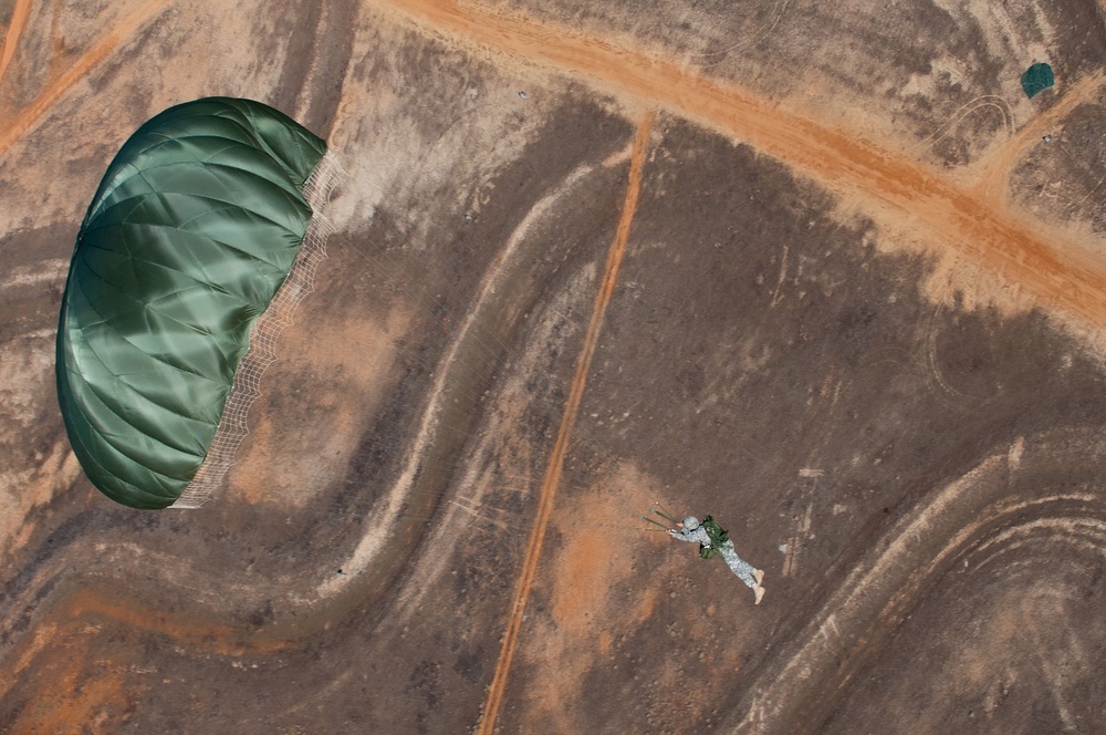 Paratroopers jump from helicopters