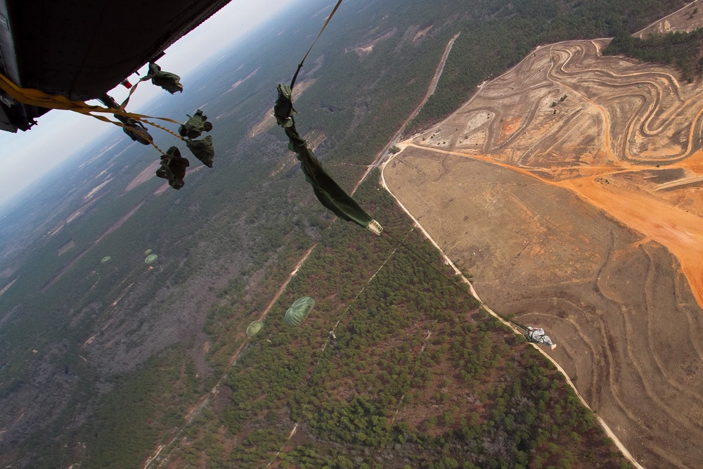 Paratroopers jump from helicopters