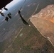 Paratroopers jump from helicopters