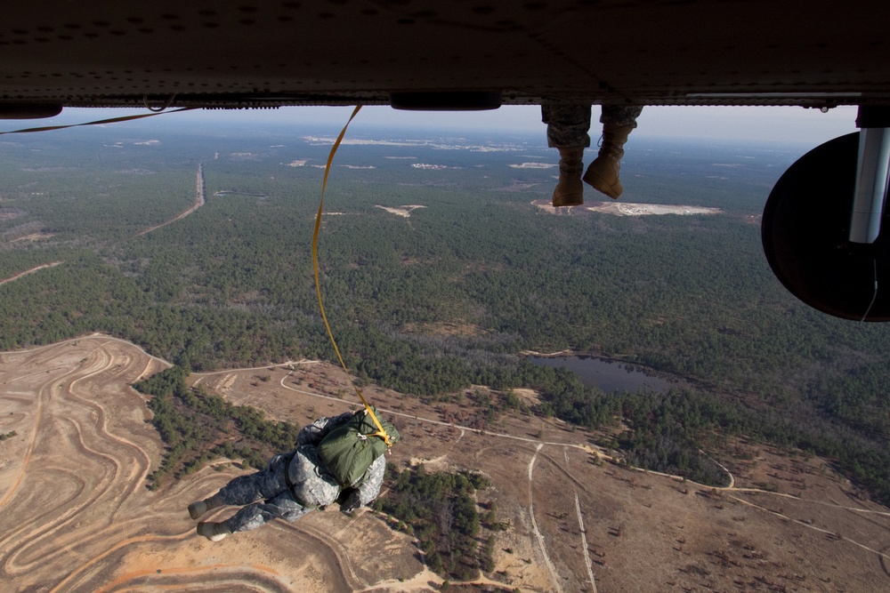 Paratroopers jump from helicopters