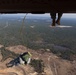 Paratroopers jump from helicopters