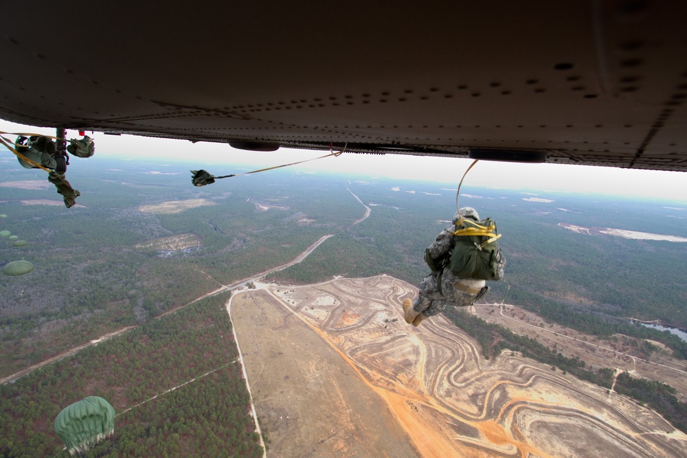 Paratroopers jump from helicopters