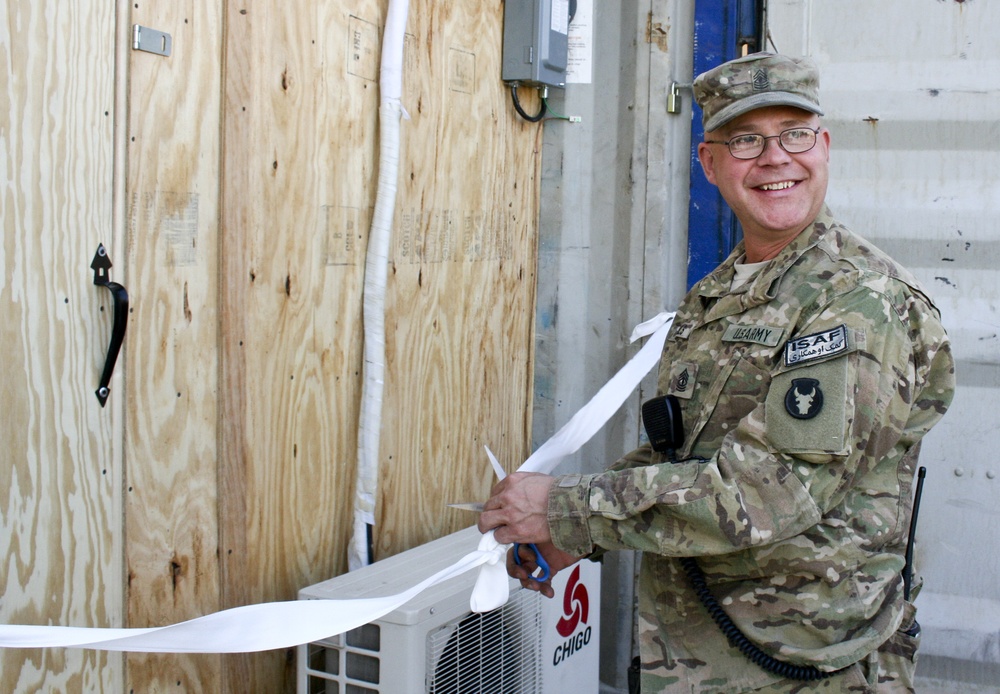 Headquaters 1st Sgt. cuts ribbon opening new PX