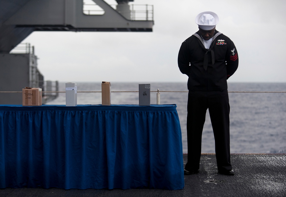 Sailors perform burial-at-sea ceremony