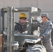 Three Soldiers maintain regulated waste yard
