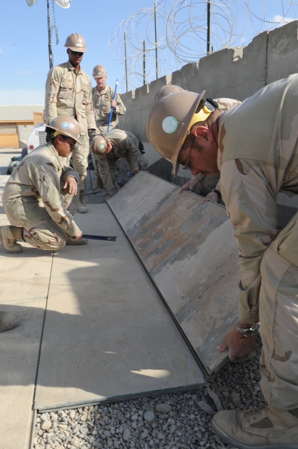 Seabees Lay AM2 matting for a basketball court