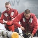 Sailors move aircraft weapons