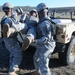 Soldiers from the 525th Military Police Battalion load an injured comrade into a tactical vehicle