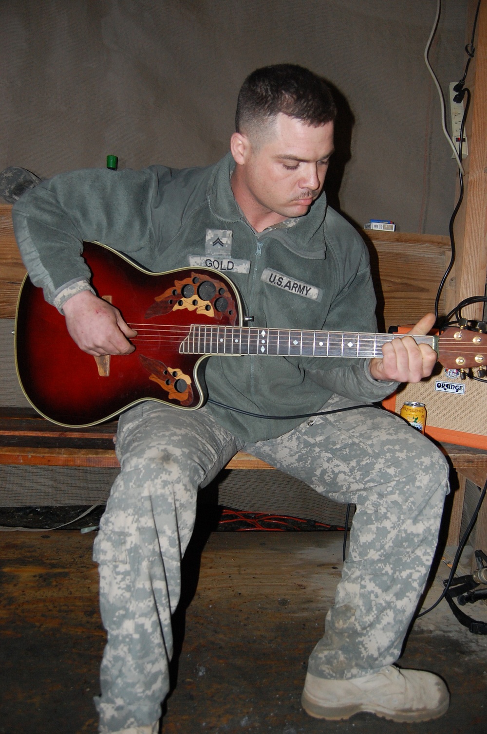 Finger-pickin’ good: Soldier strums guitar, writes songs from his heart