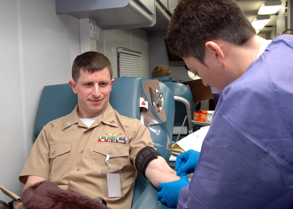 Lt. Mathew Mariano looks on as his blood donation begins during the Armed Services Blood Program (ASBP) blood drive at Commander, U.S. Second Fleet headquarters, Feb. 7